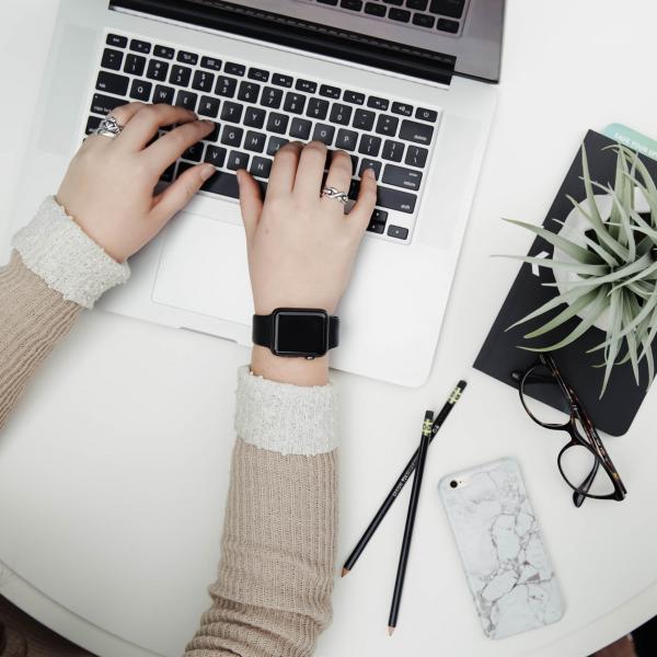 Woman Typing on Laptop