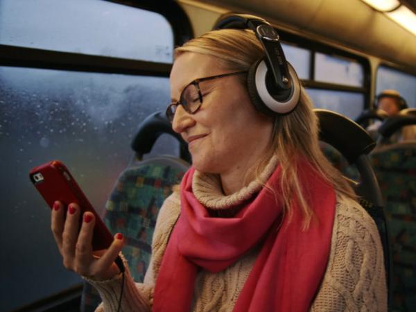 Woman using Online Services on Bus