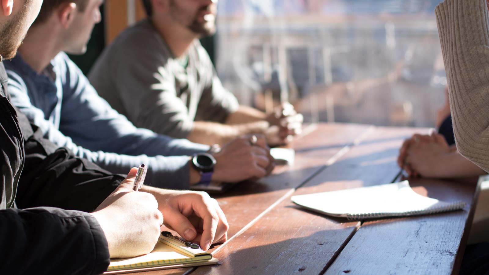 Men receiving advice at a table