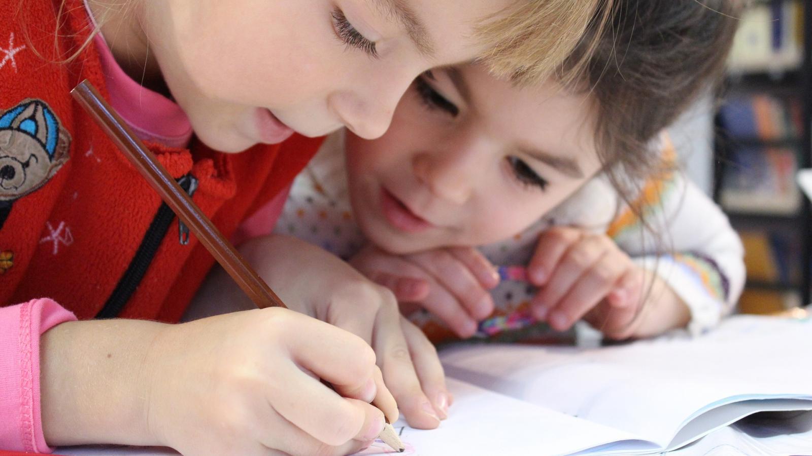 Two children reading a book