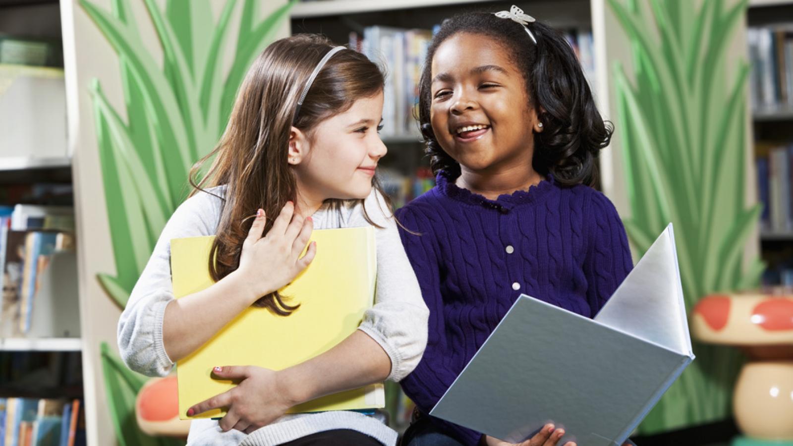 Two girls enjoying books