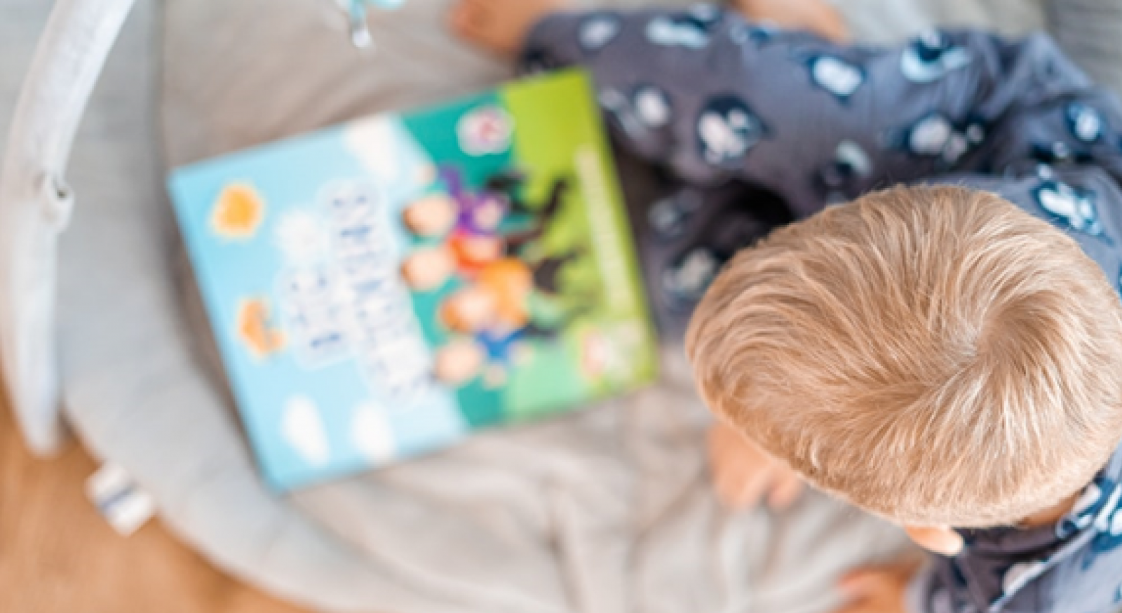 A young boy looks at a book